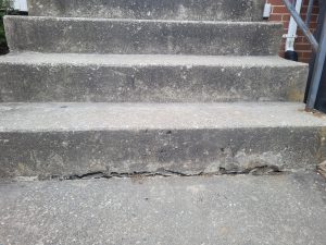 The crack at the bottom of the steps.